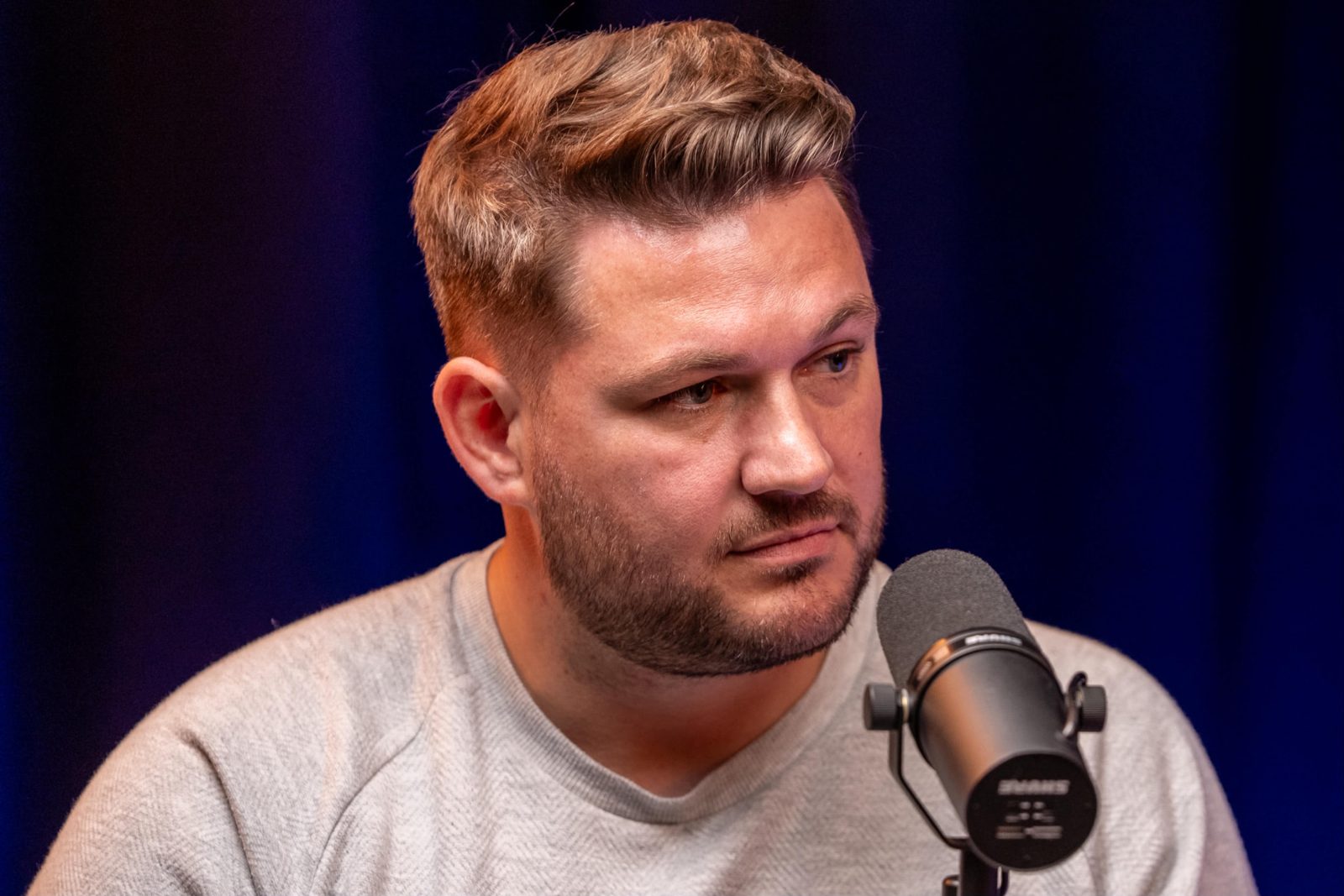 Close portrait of a guest speaking into a studio microphone