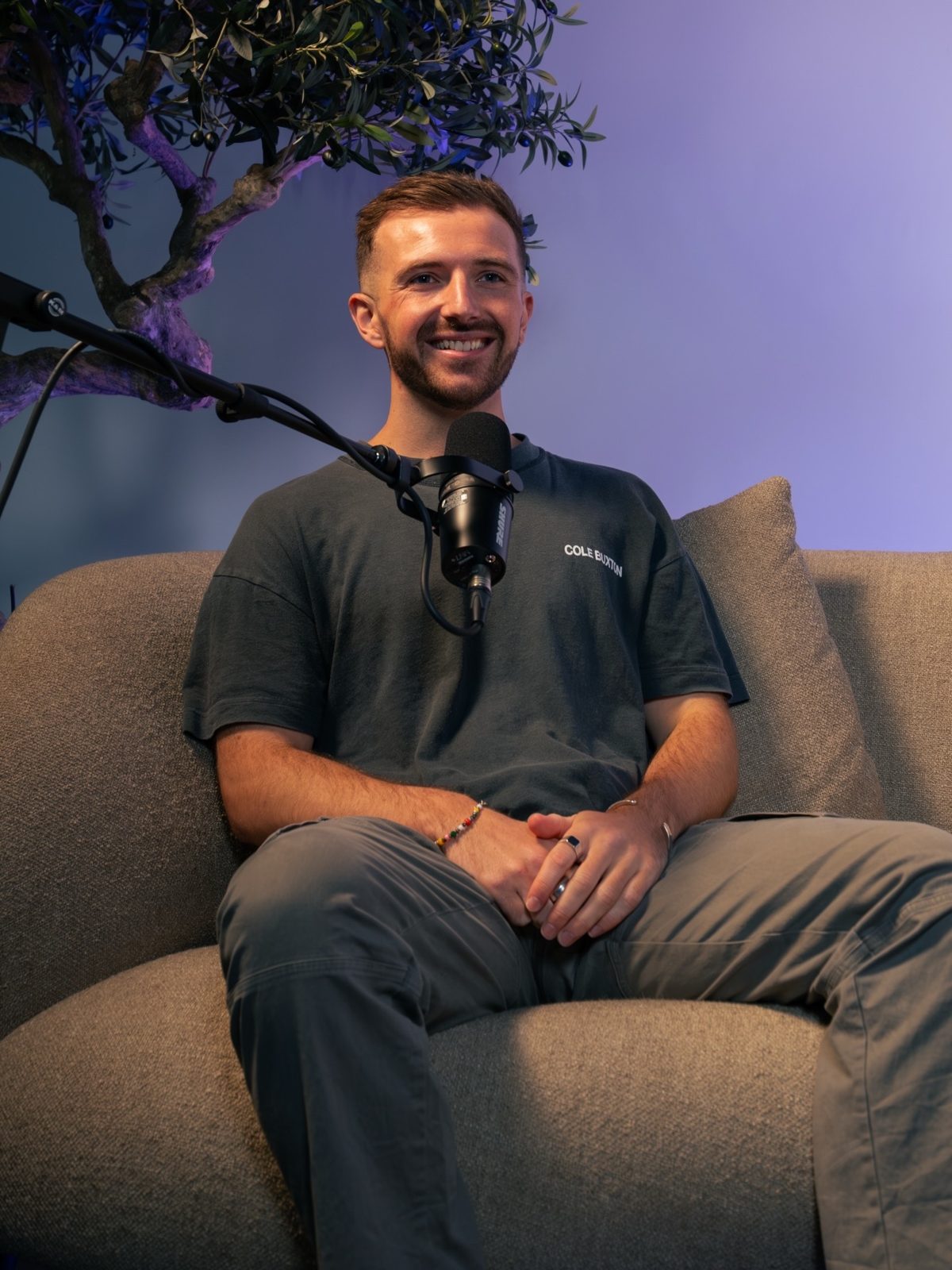 Guest smiling into a studio microphone on set